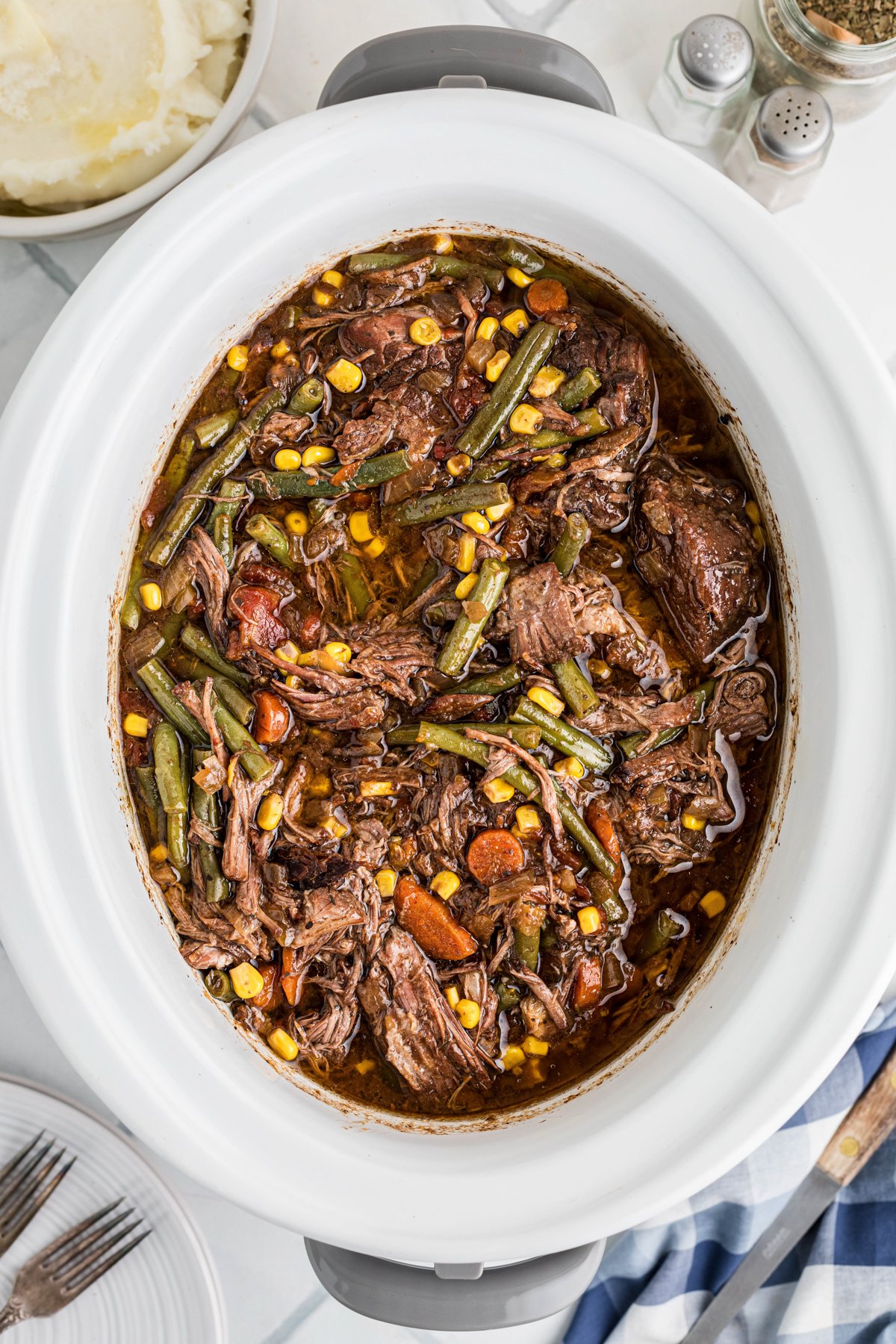 Slow cooker shredded beef dinner after cooking in a crockpot.
