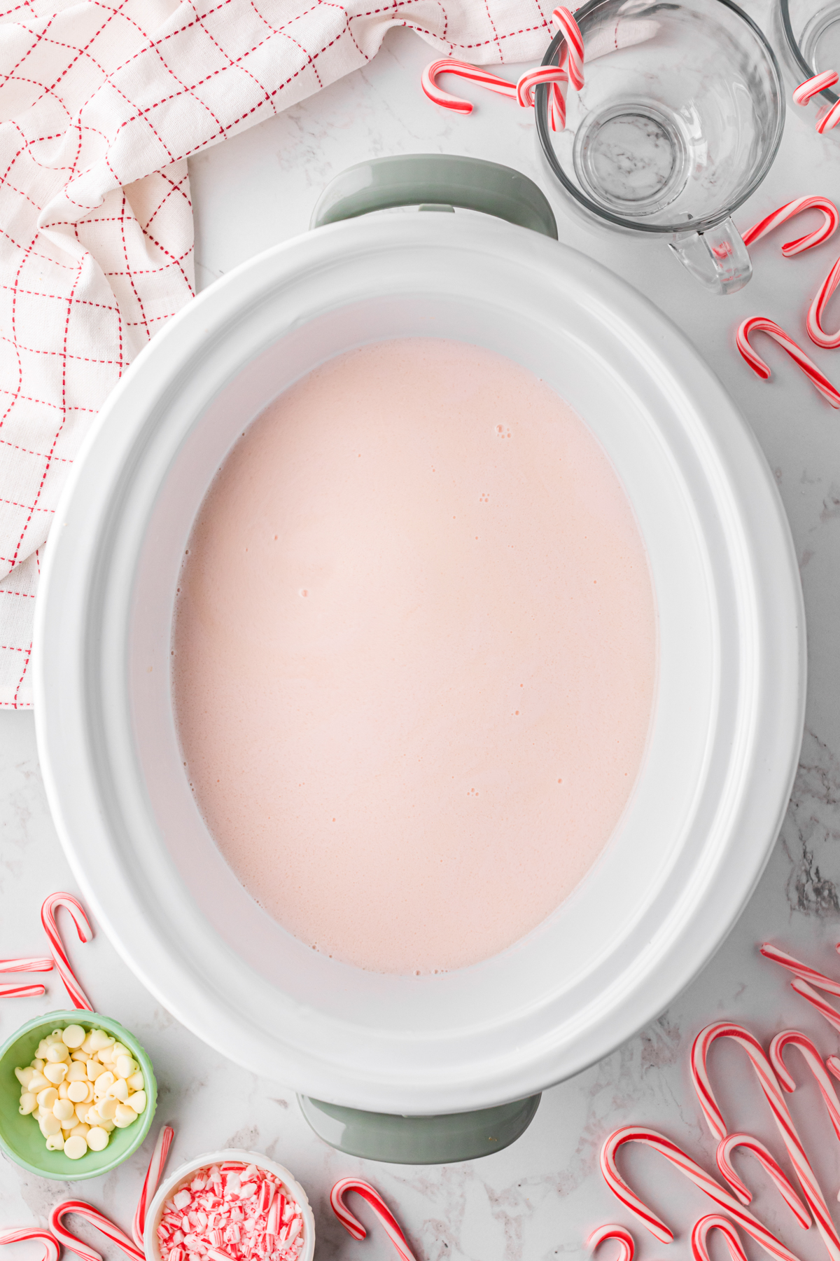 Candy cane hot chocolate in a crockpot after cooking.