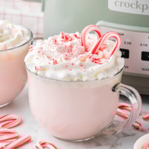 slow cooker candy cane hot chocolate in front of a crockpot.