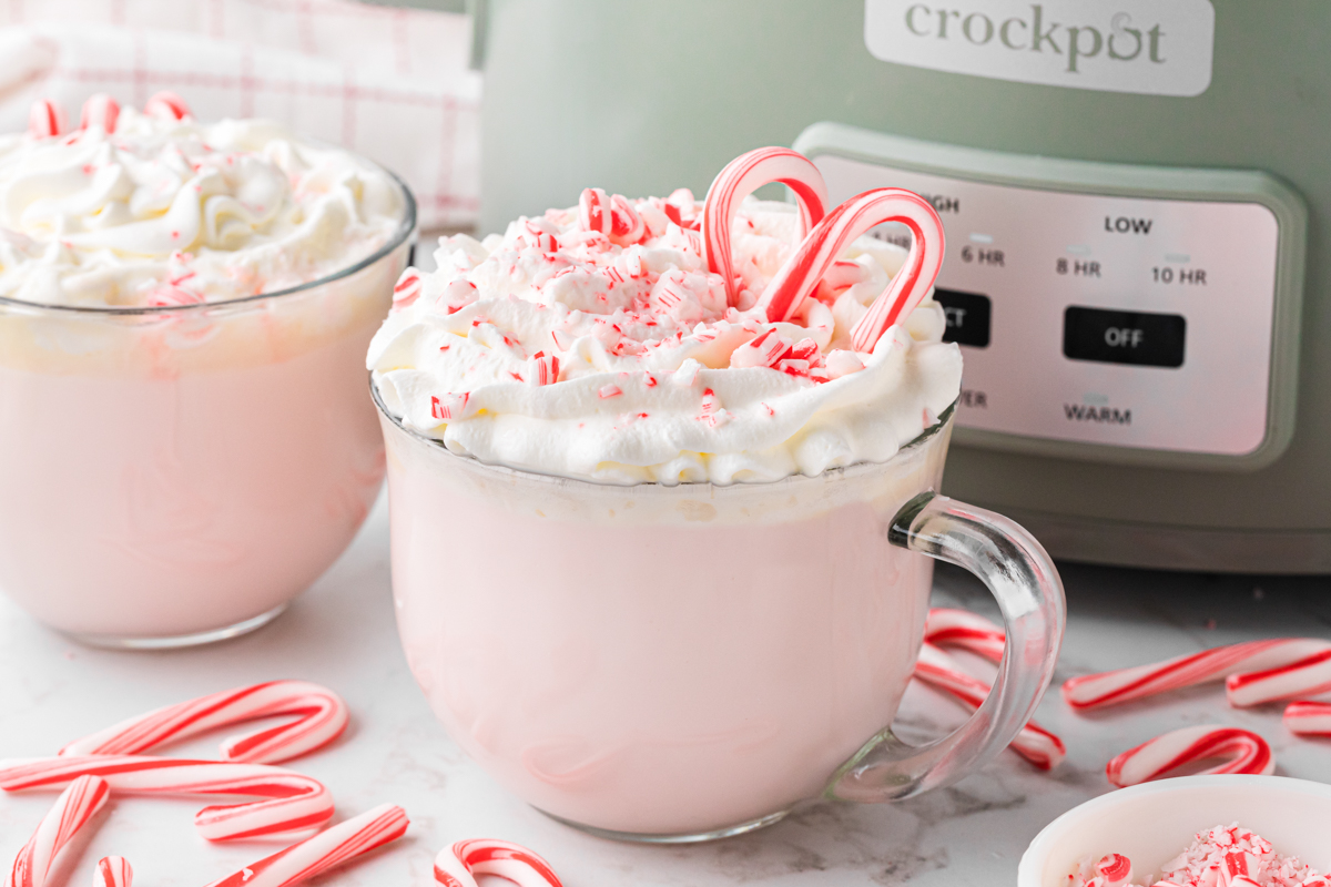 slow cooker candy cane hot chocolate in front of a crockpot.