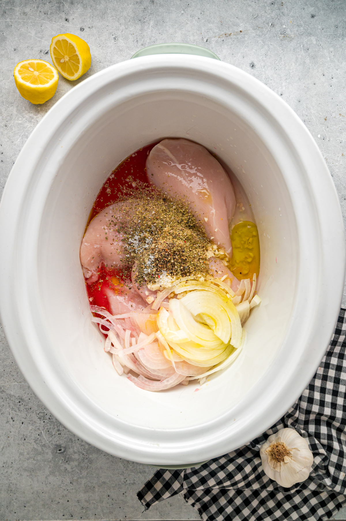 Ingredients for slow cooker chicken gyros in a crockpot.