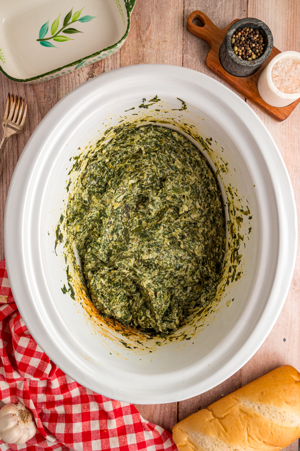 Creamed spinach in a crockpot after cooking.
