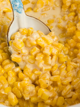 Slow cooker honey butter corn with a spoon in it.