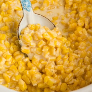 Slow cooker honey butter corn with a spoon in it.