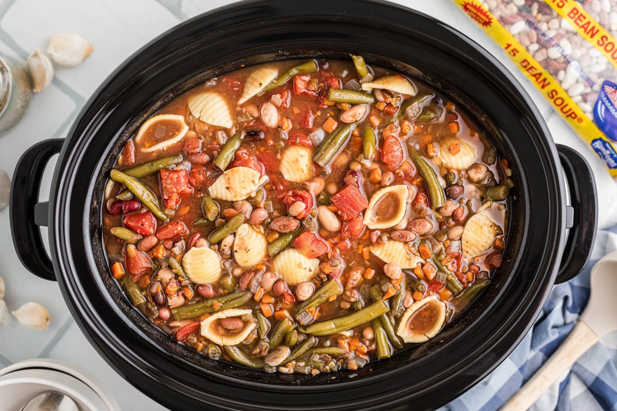 Slow cooker 15 bean minestrone soup with bag of beans in the background.