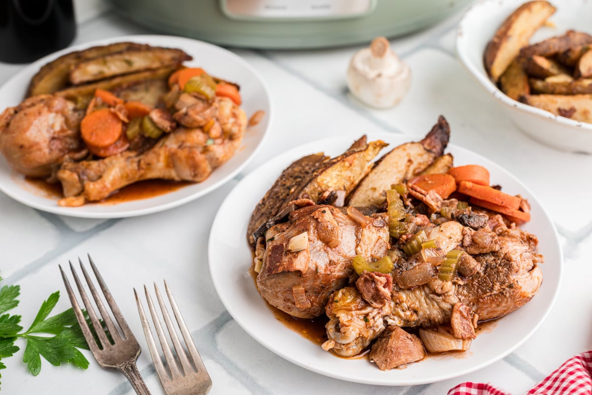 Two plates of slow cooker merlot chicken.