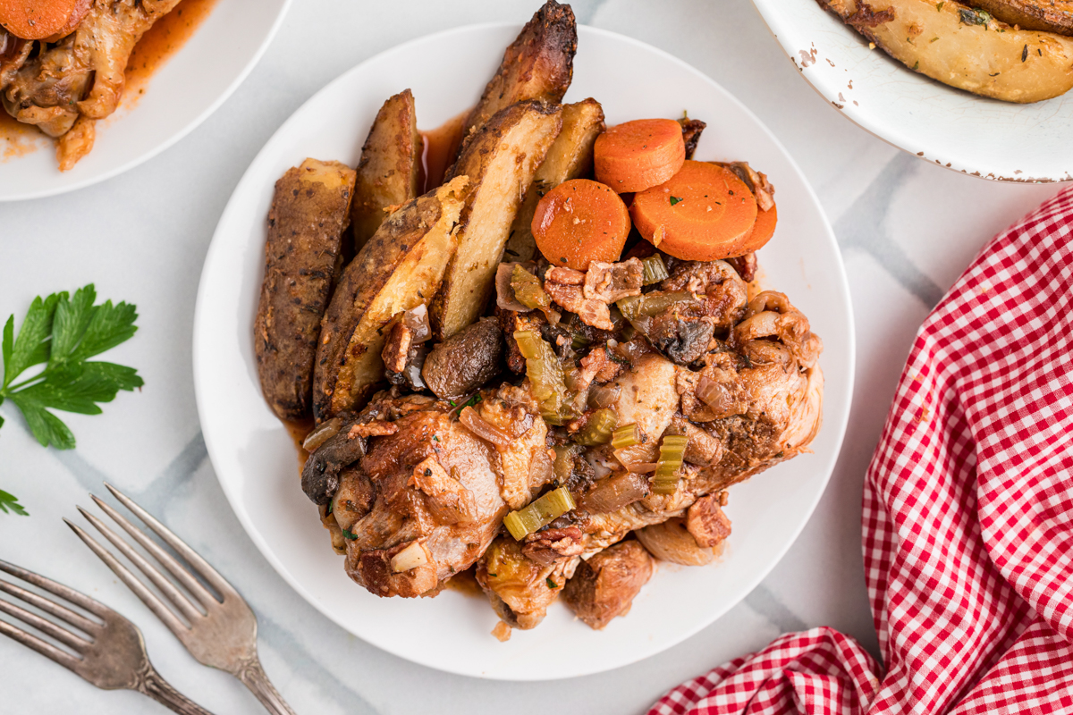 A serving of slow cooker merlot chicken on a plate.