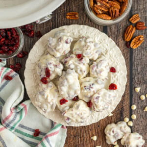 Overhead shot of slow cooker white chocolate cranberry clusters on a plate.