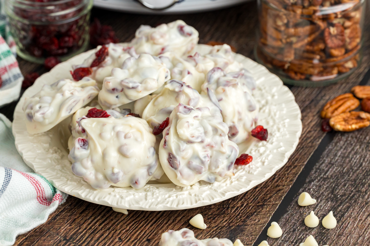 Slow cooker white chocolate cranberry clusters on a plate.