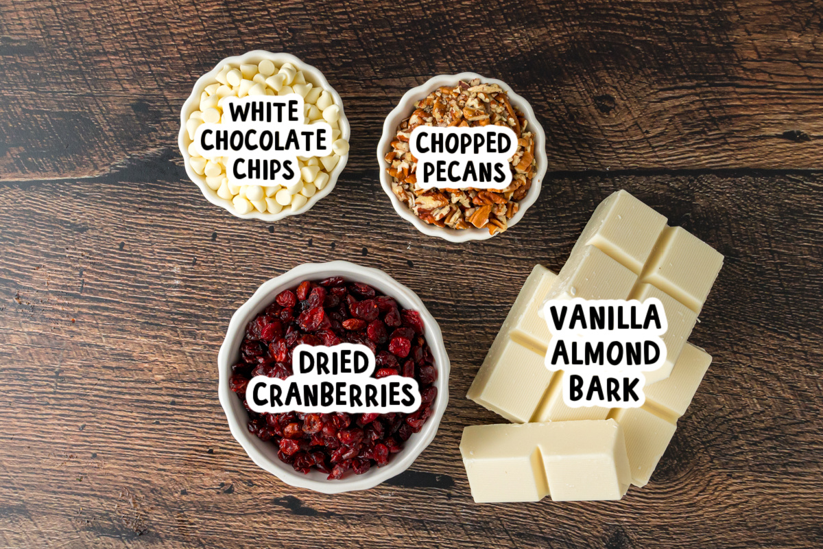 Ingredients for slow cooker white chocolate cranberry clusters on a table.