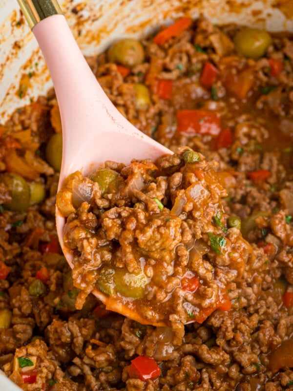 A ladle scooping out some slow cooker picadillo.