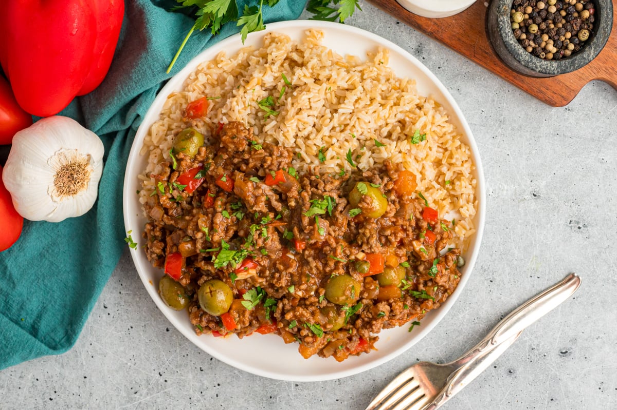 Slow cooker picadillo and rice on a white plate.