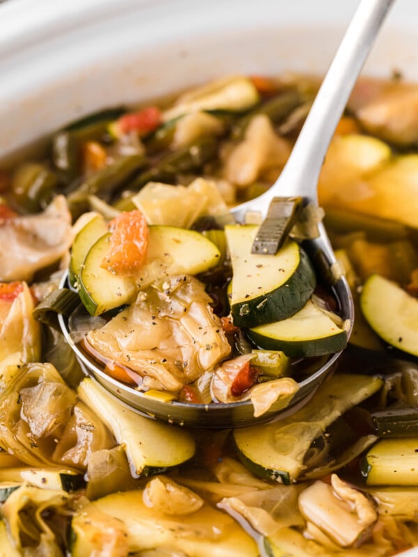 Close-up of slow cooker weight loss soup with a ladle.