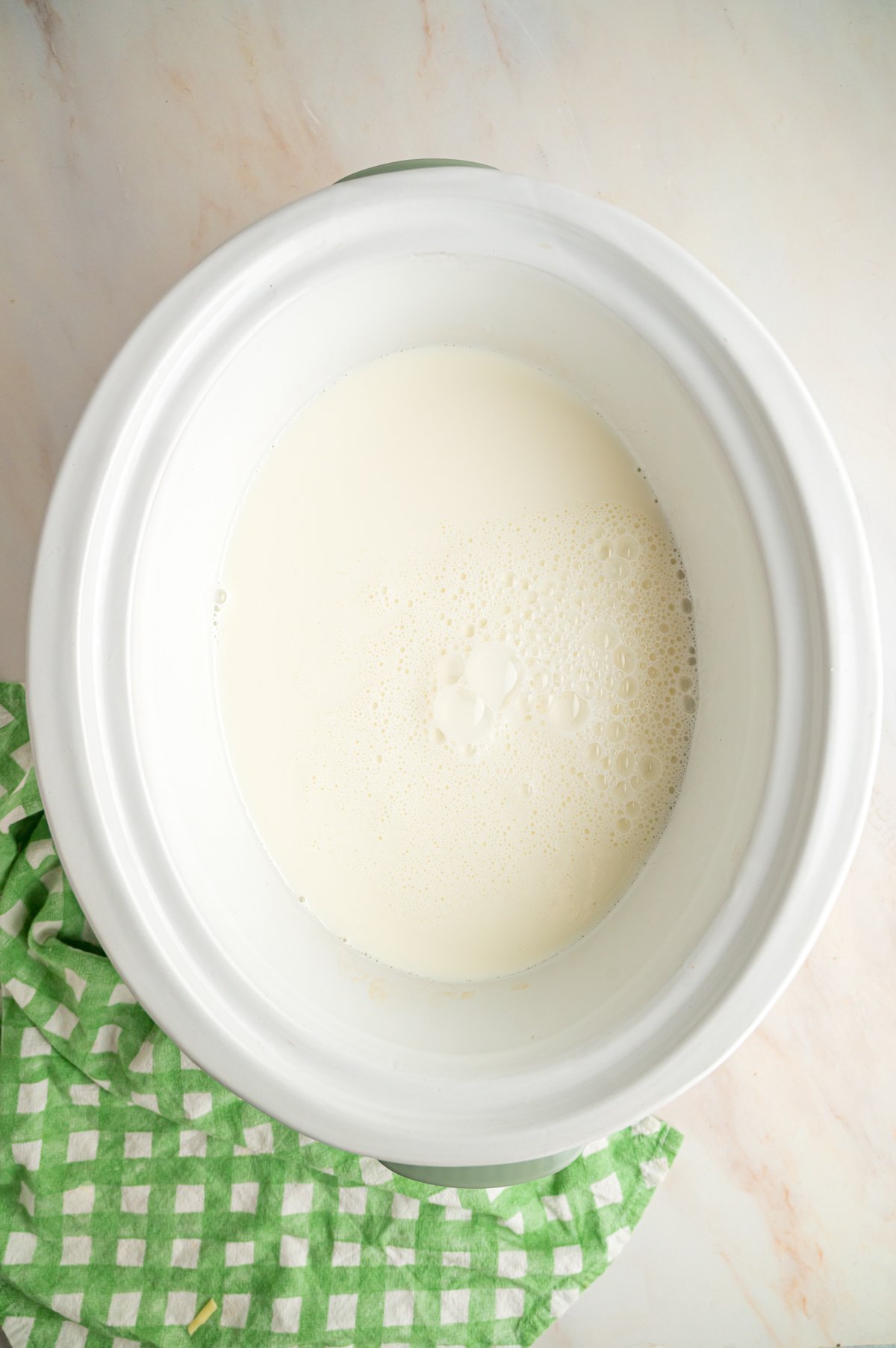Whole milk in a crockpot.