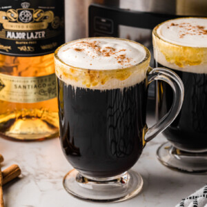Two glass mugs filled with slow cooker spanish coffee.