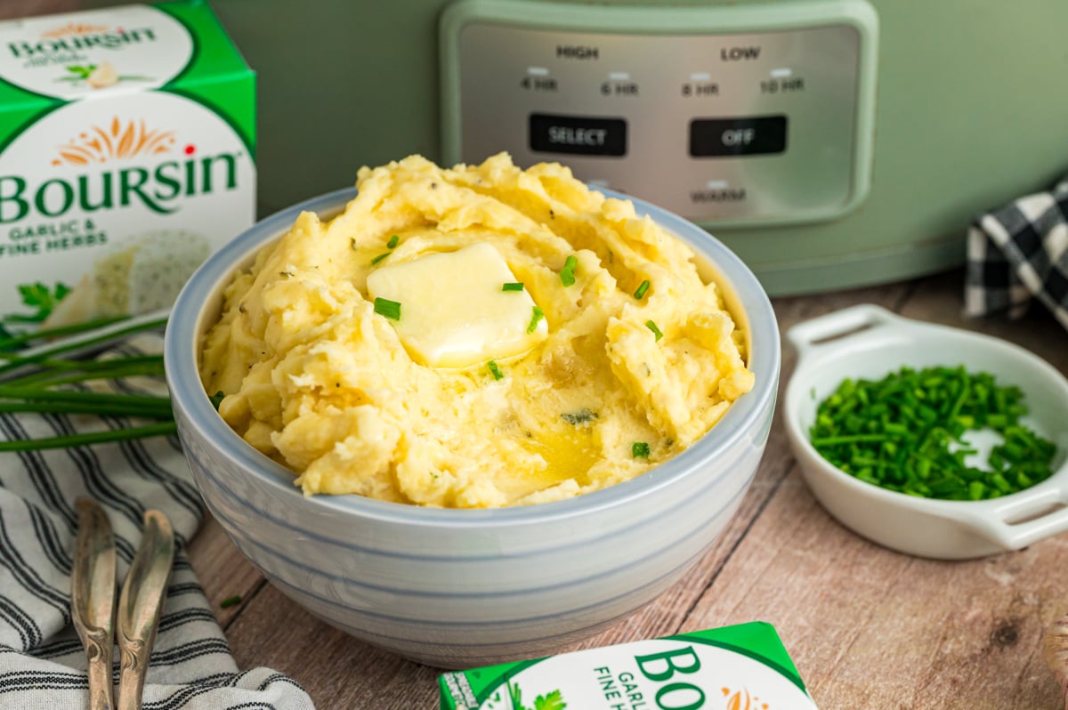 Slow cooker boursin cheese potatoes in a blue bowl.