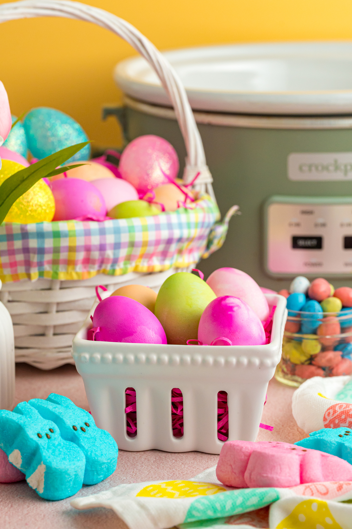 Slow cooker easter eggs in baskets on a table.