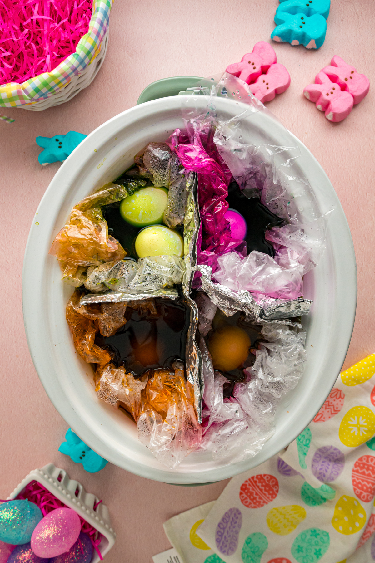 Colored easter eggs in a crockpot after cooking.
