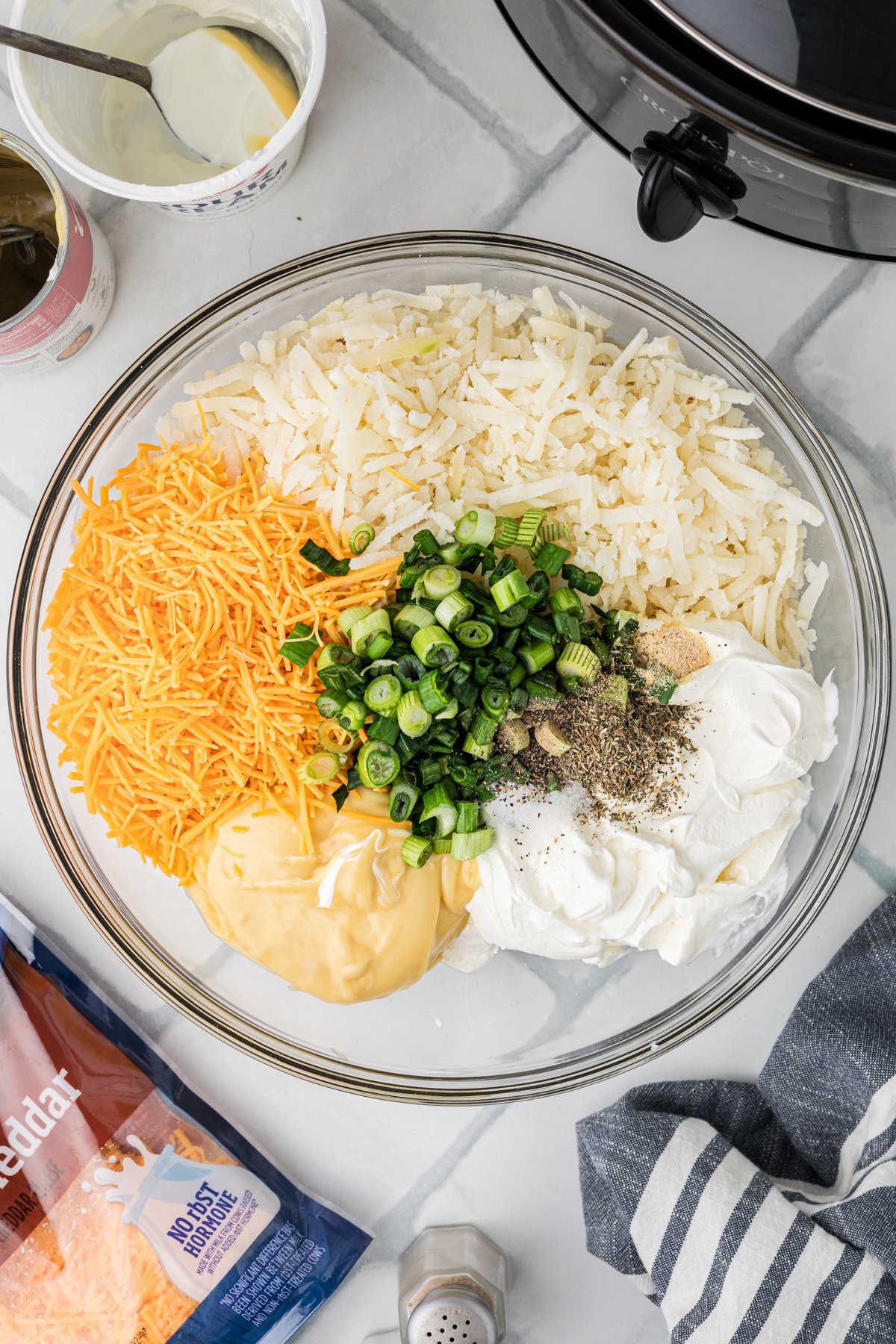 Party potatoes ingredients in a mixing bowl before combining.