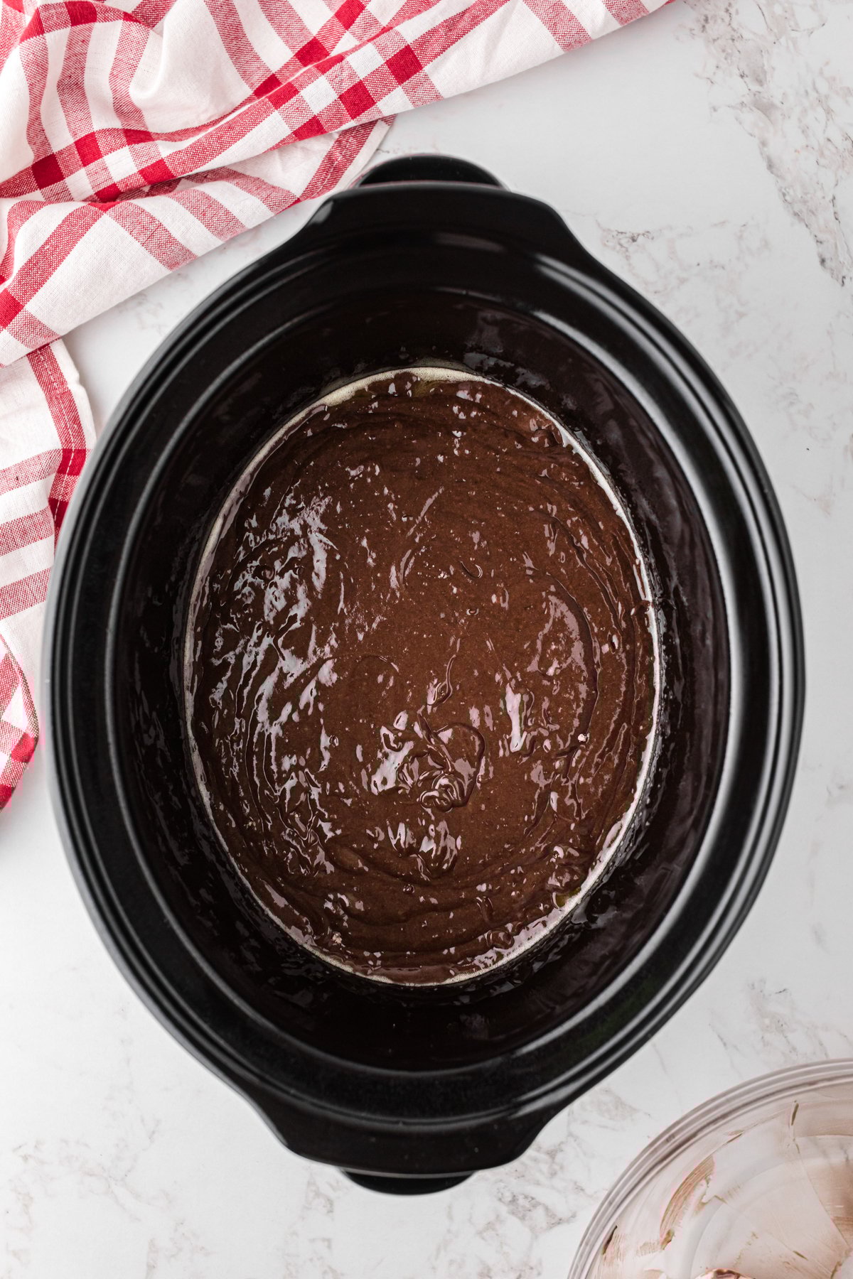 Prepared cake mix in a crockpot.