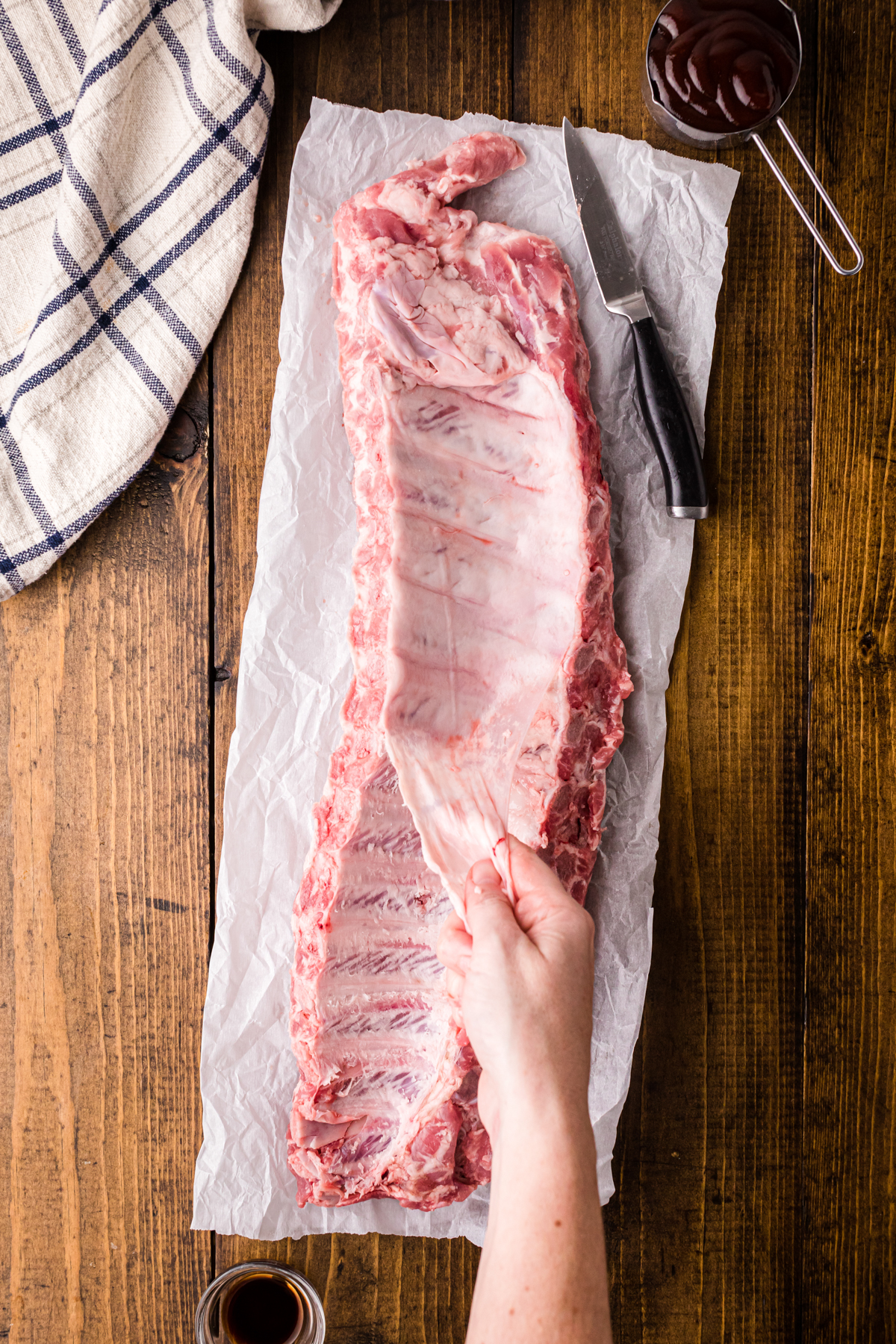 Removing the silver skin from a rack of ribs.