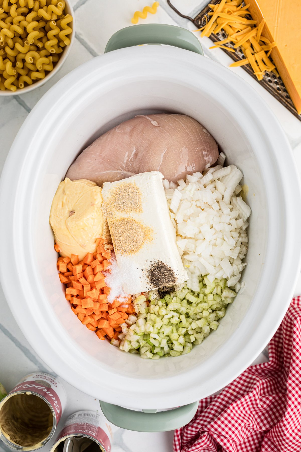 Ingredients for chicken broccoli pasta in a slow cooker.