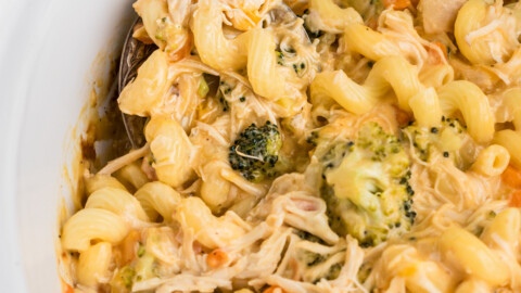 Slow cooker chicken broccoli pasta with a spoon in it.