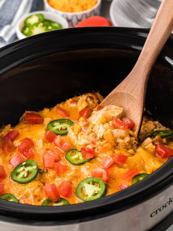 Slow cooker fiesta chicken and rice casserole with a spoon in it.