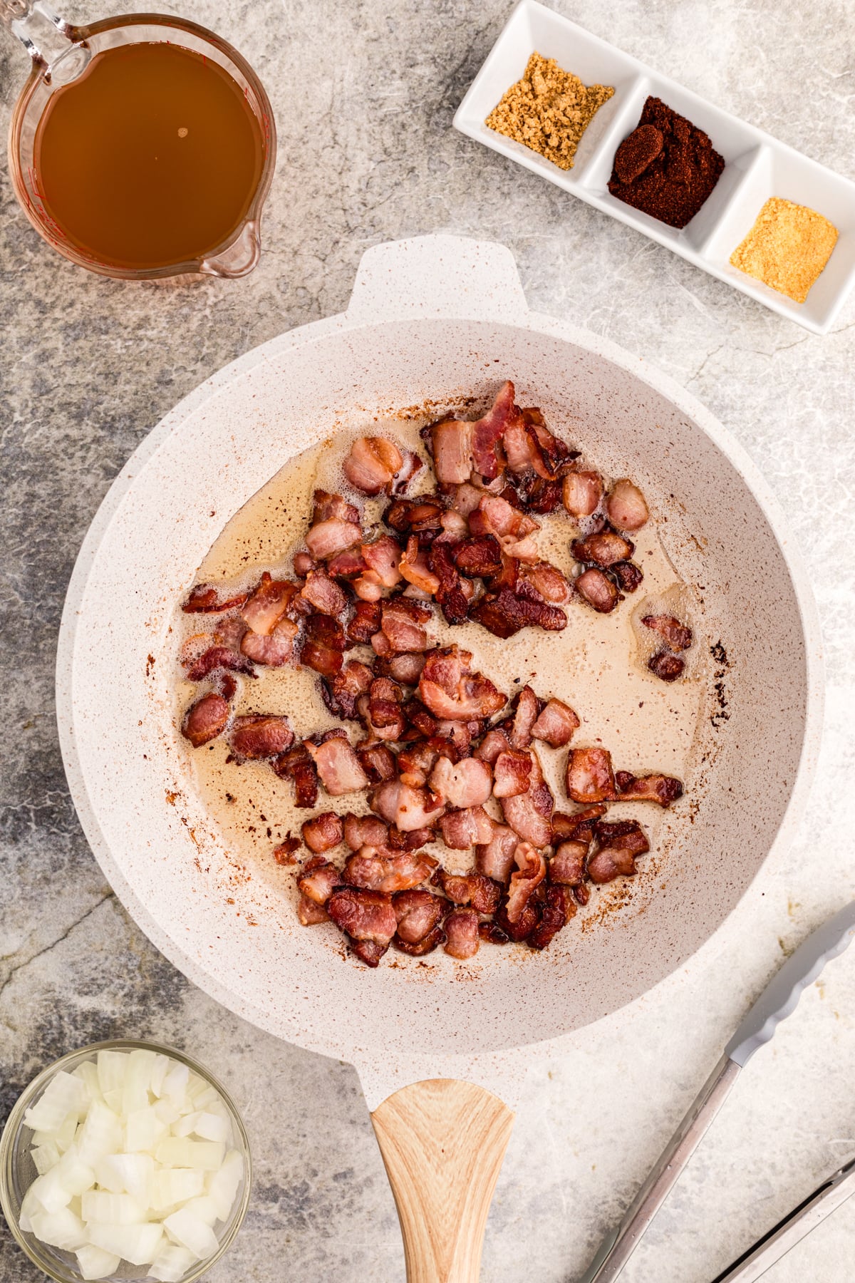 Bacon cooking in a skillet.
