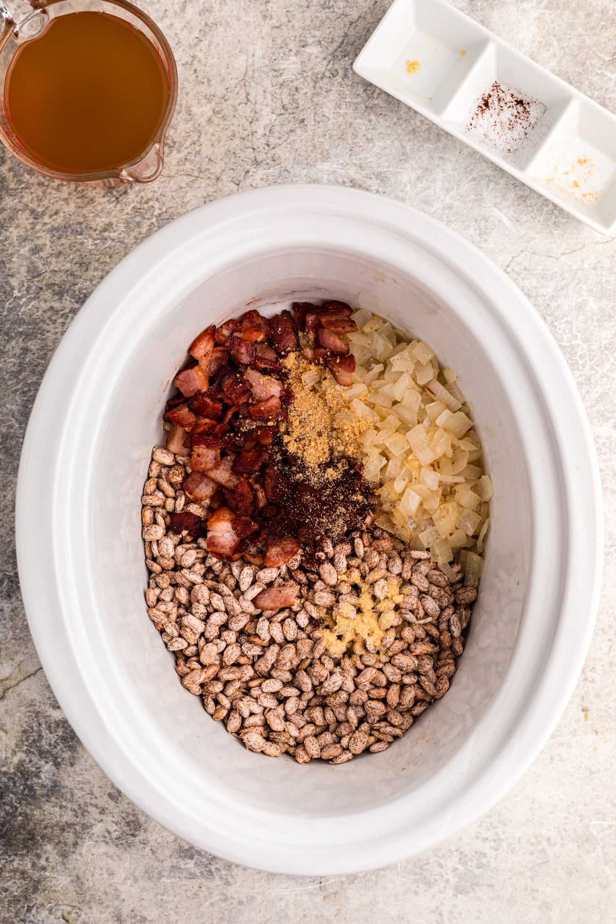 Ingredients for slow cooker pinto beans in a crockpot.