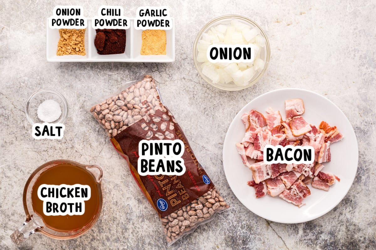 Ingredients for slow cooker pinto beans on a table.