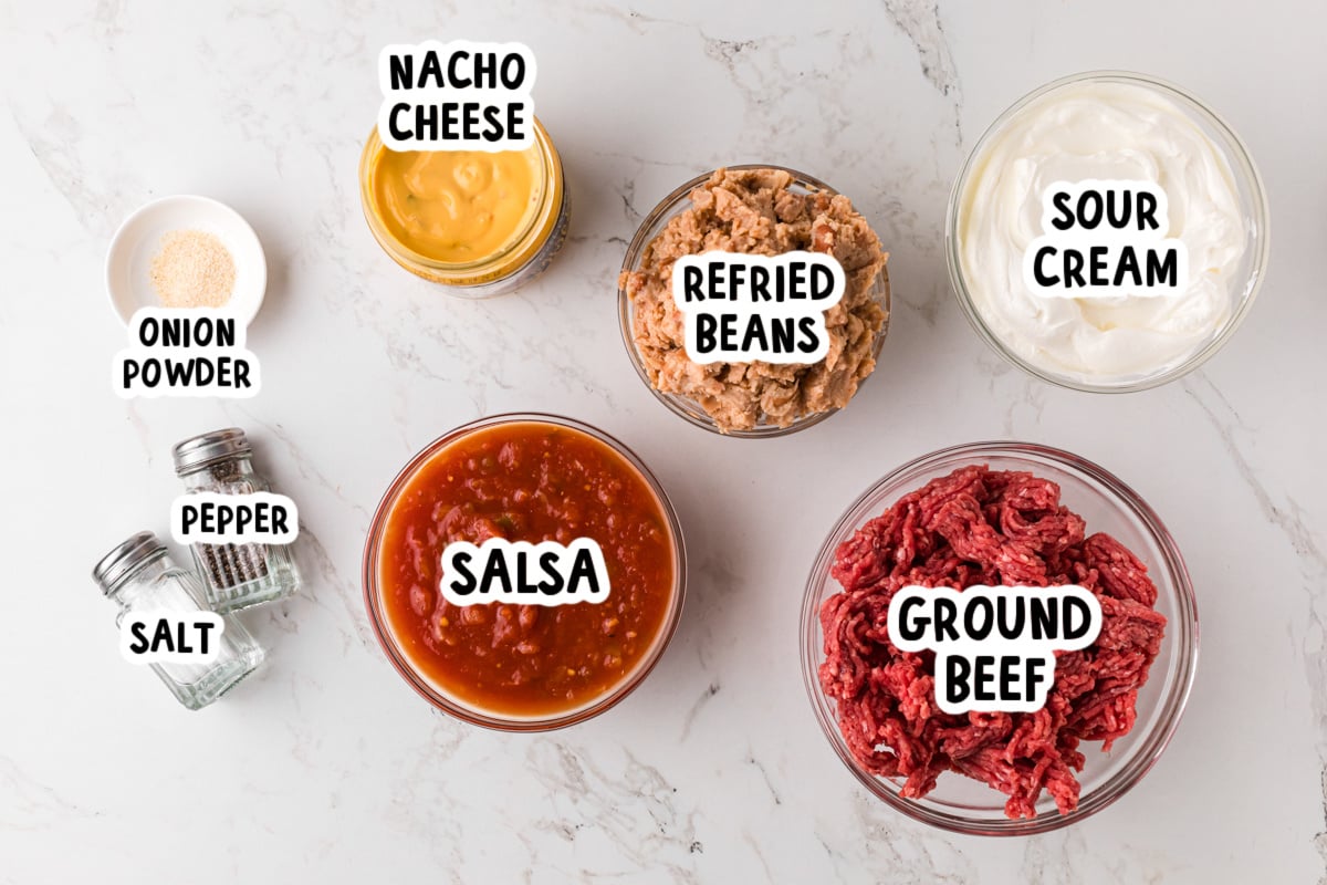 Ingredients for slow cooker taco dip on a table.