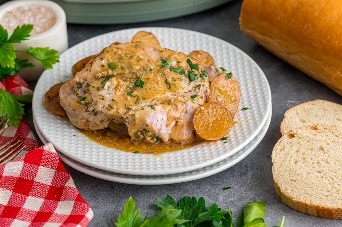 A serving of butter ranch pork chops and potatoes on a plate.