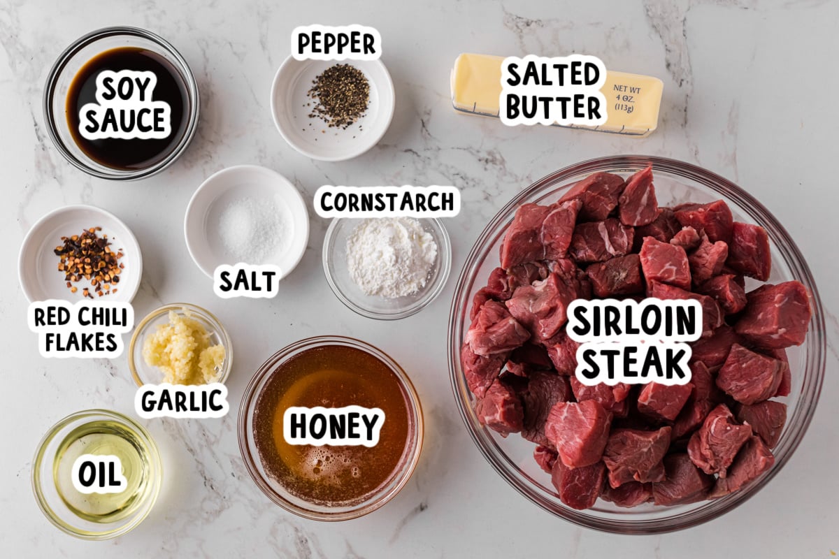 Ingredients for making honey garlic steak bites on a table.