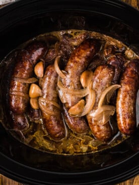Bratwurst cooked with beer, onions, and garlic in a crockpot.