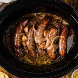 Bratwurst cooked with beer, onions, and garlic in a crockpot.