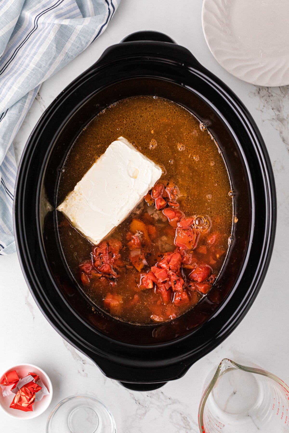 Water added to taco soup ingredients in a slow cooker.