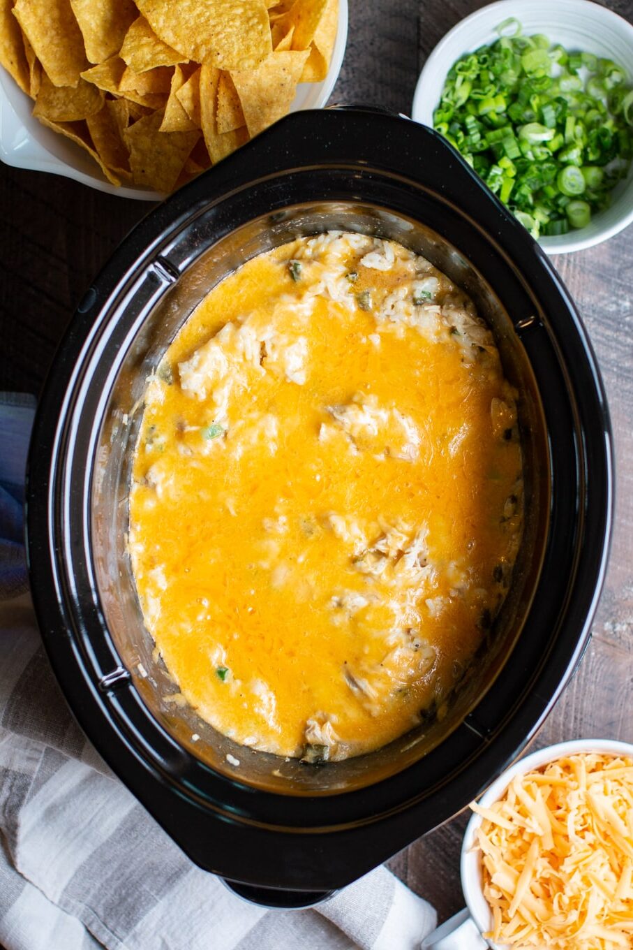 casserole in a slow cooker with melted cheese on top.