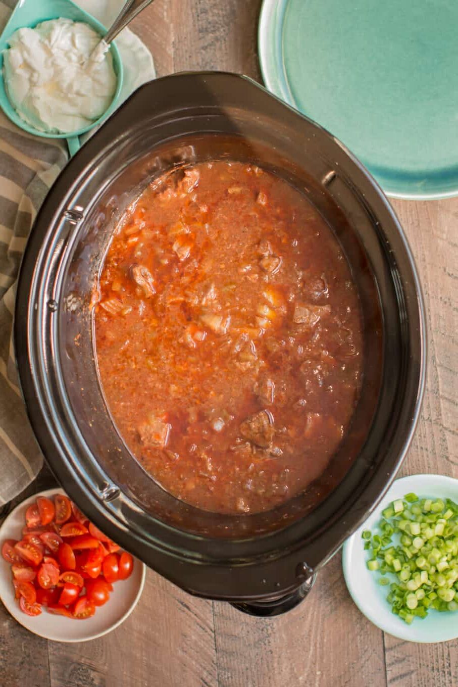 beef cooked in sauce in slow cooker.