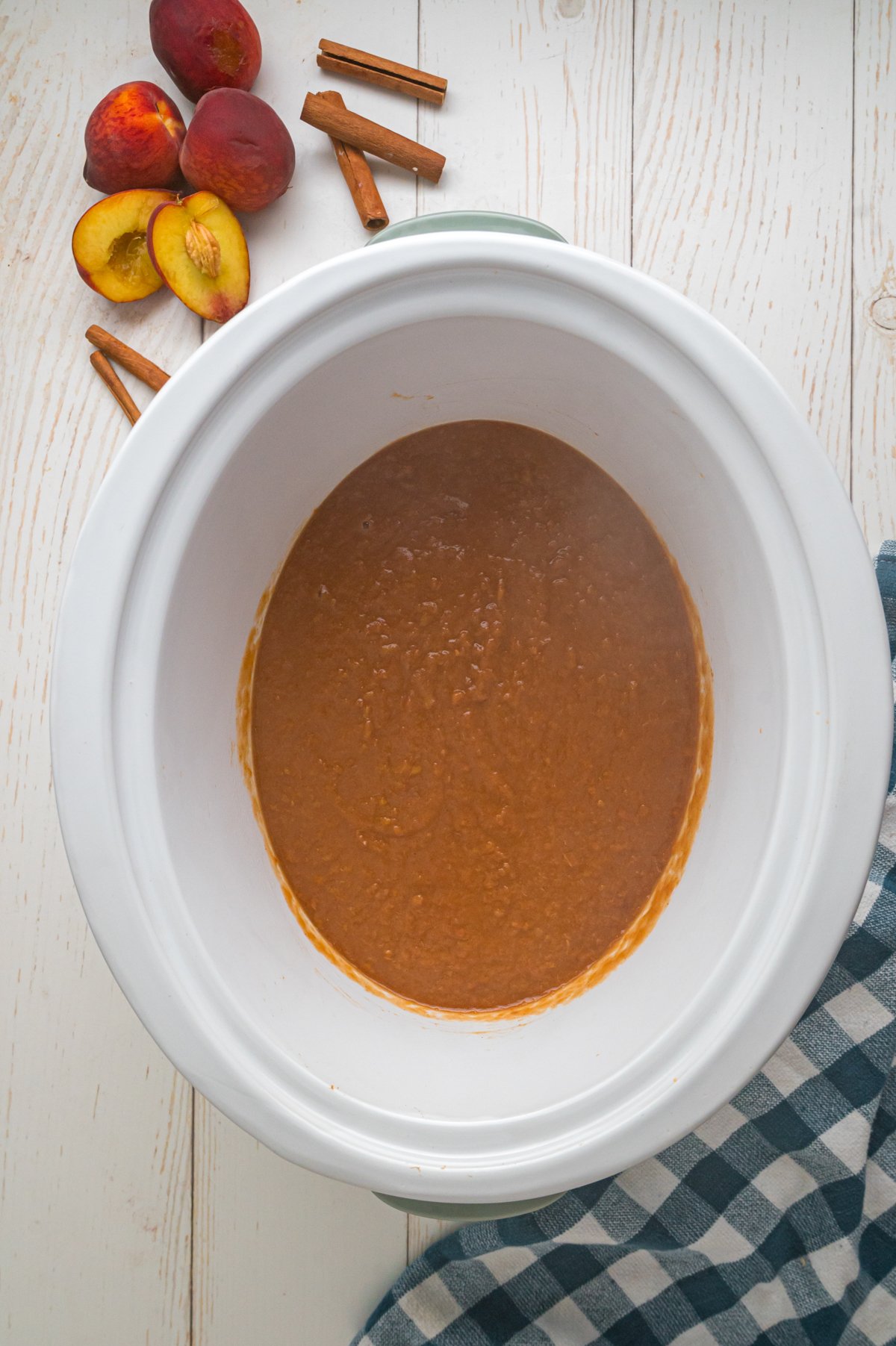 done cooking peach butter in a slow cooker.