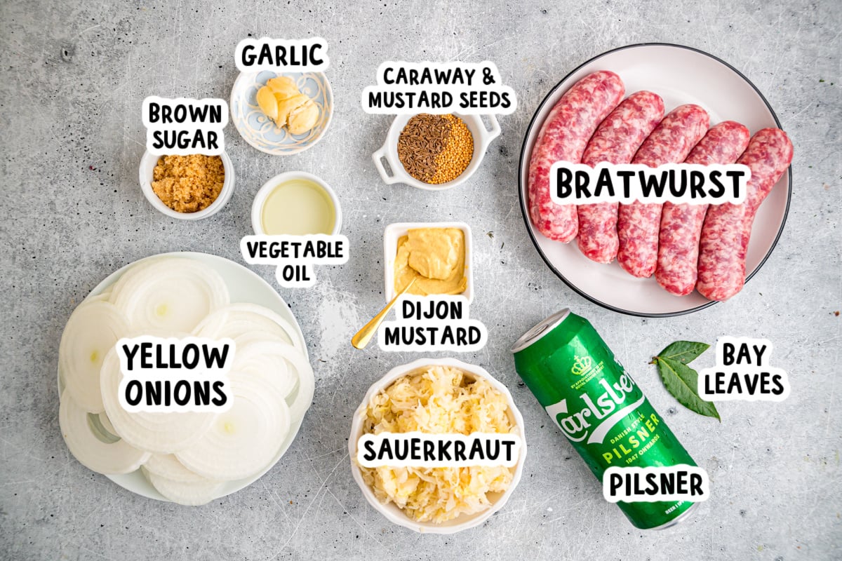 Ingredients for making brats and sauerkraut on a table.