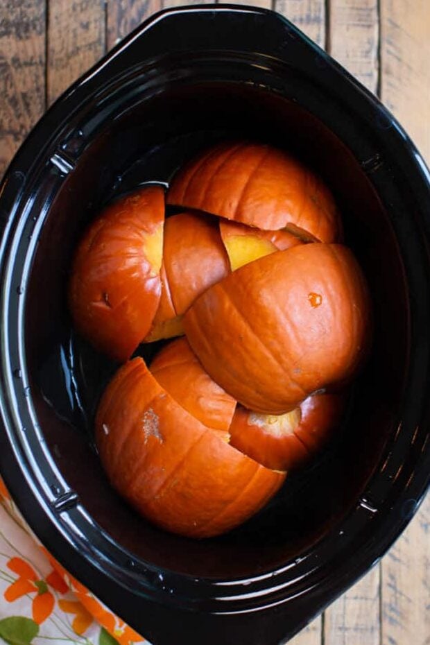 cooked pumpkin pieces in the slow cooker.