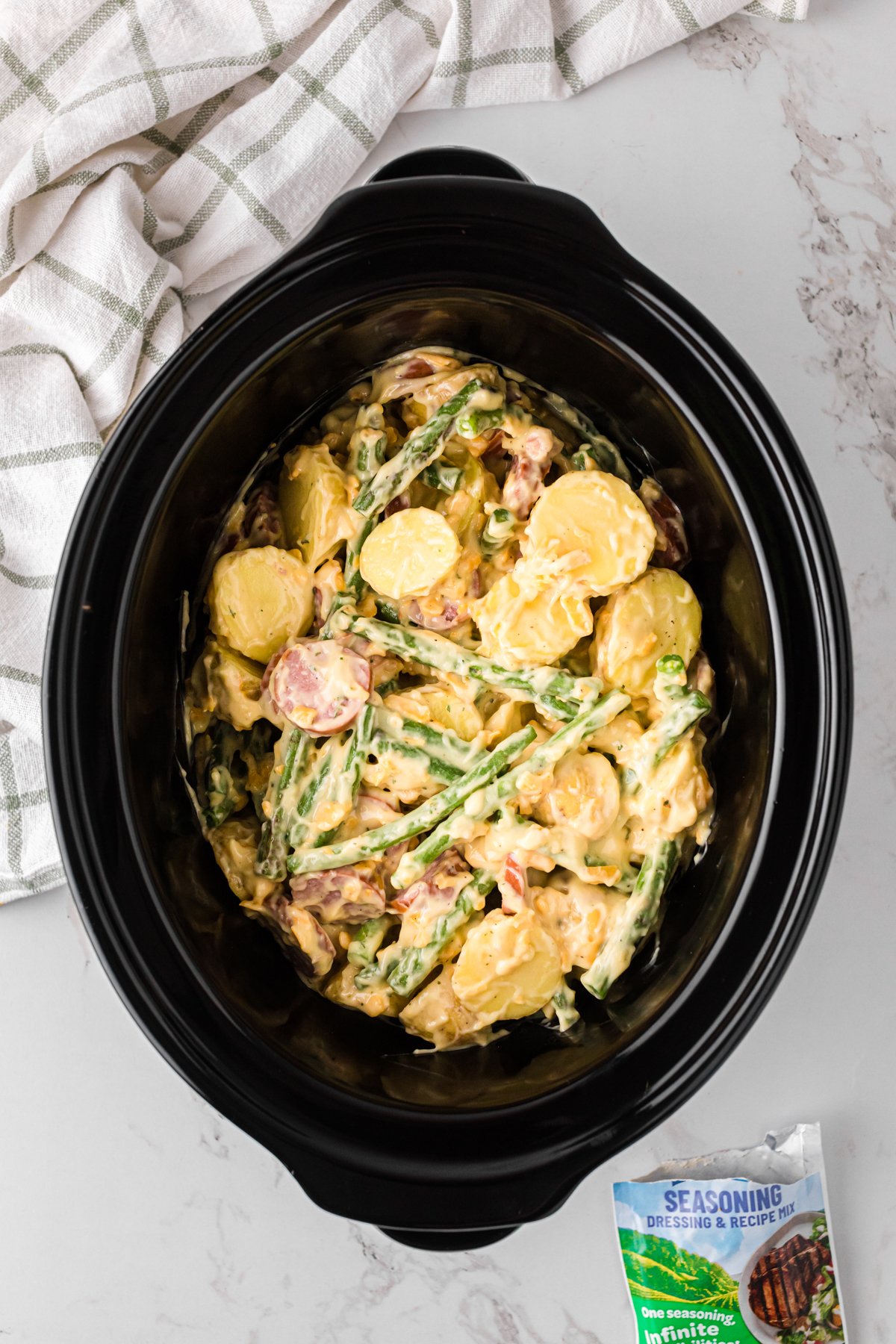 Swamp potato mixture in a crockpot before cooking.