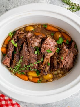 Pot roast with veggies in a slow cooker.