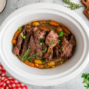 Pot roast with veggies in a slow cooker.