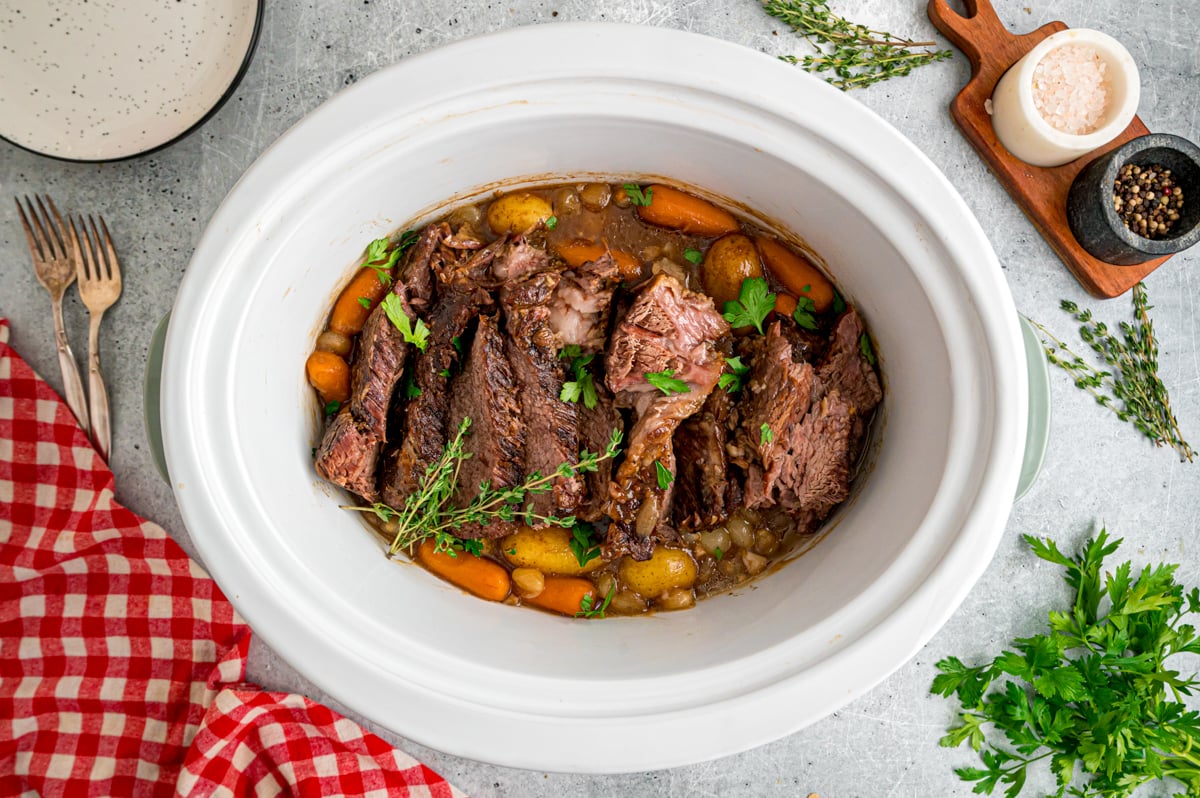 Pot roast with veggies in a slow cooker.