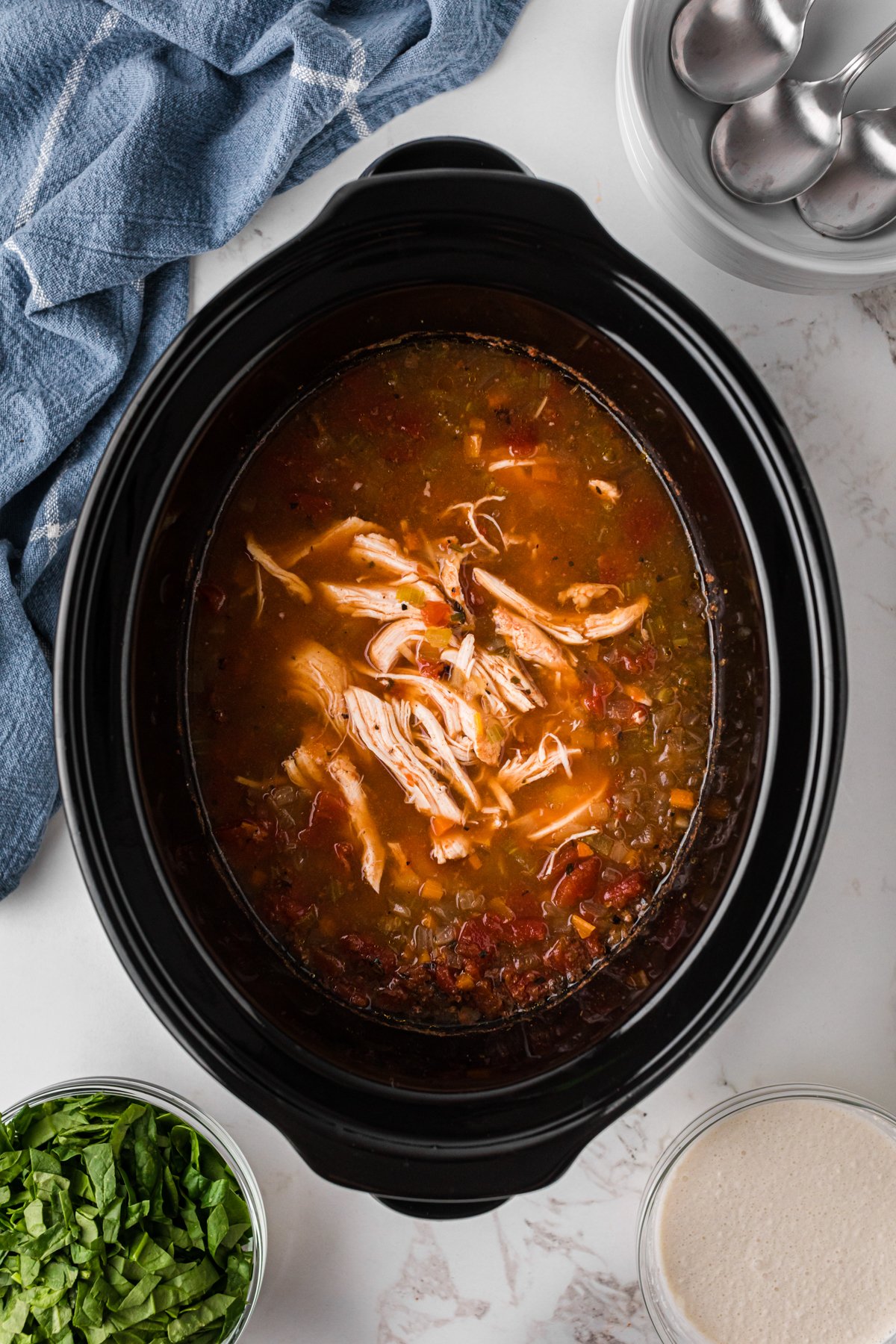 Shredded chicken in a crockpot.