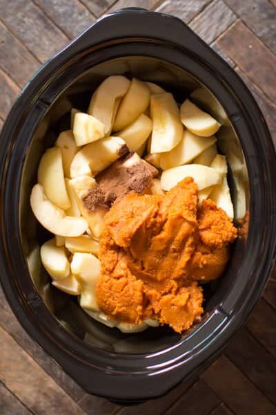 sliced apples, seasonings, and pumpkin puree in a slow cooker.