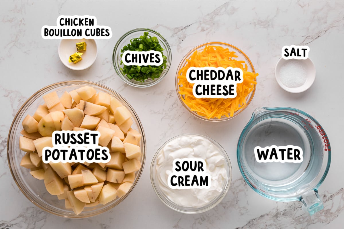 Ingredients for cheesy mashed potatoes on a table.