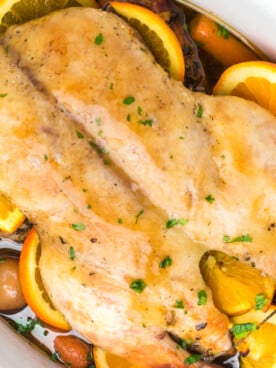 Cooked whole duck and veggies in a crockpot.